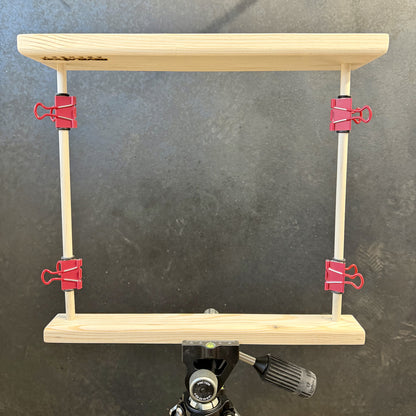 Revelation Archery paper tuner mounted upside down in arca-swiss clamp on tripod